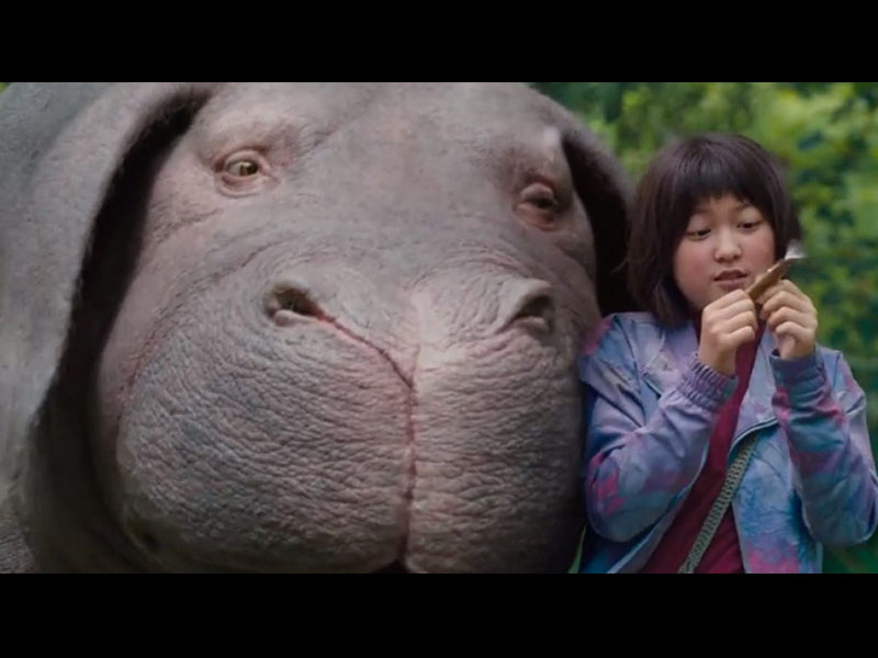 Okja que inlui no elenco Jake Gyllenhaal e Tilda Swinton Uma estória crítica de cunho ecológico, mas que falava sobre o sentido da amizade, um visionário diretor vindo da Coreia do Sul, e cujas obras são bastante badaladas por aí, e um elenco que incluía Jake Gyllenhaal e Tilda Swinton